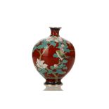 A RED CLOISONNÉ VASE DECORATED WITH A NIGHTINGALE. Meiji period. Of globular form with a narrow