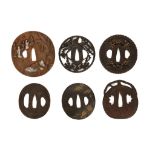 SIX TSUBA. Edo period or later. Including an oval shaped copper tsuba, decorated in high relief with