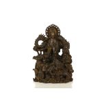 AN UNUSUAL BRONZE OKIMONO OF KANNON. Meiji period. Heavily cast with traces of gilding on the