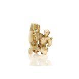 AN IVORY OKIMONO. Meiji period. Depicting a man seated looking in surprise at oni appearing from a