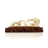 AN IVORY GROUP OKIMONO OF MONKEYS. 20th Century. Depicting a mother monkey playing tug-of-war with
