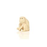 AN IVORY OKIMONO OF MONKEY. Meiji period. Naturalistically rendered with inlaid eyes, seated and