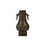 A BRONZE HU WITH ELEPHANT HEAD HANDLES. Yuan Dynasty, or later. The pear-shaped body rising to a