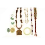 A collection of Chinese five jade pendants and a ring, together with three necklaces, a bangle and a