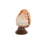 An early 20th Century carved cameo shell bedside lamp, decorated with putti harvesting grapes,