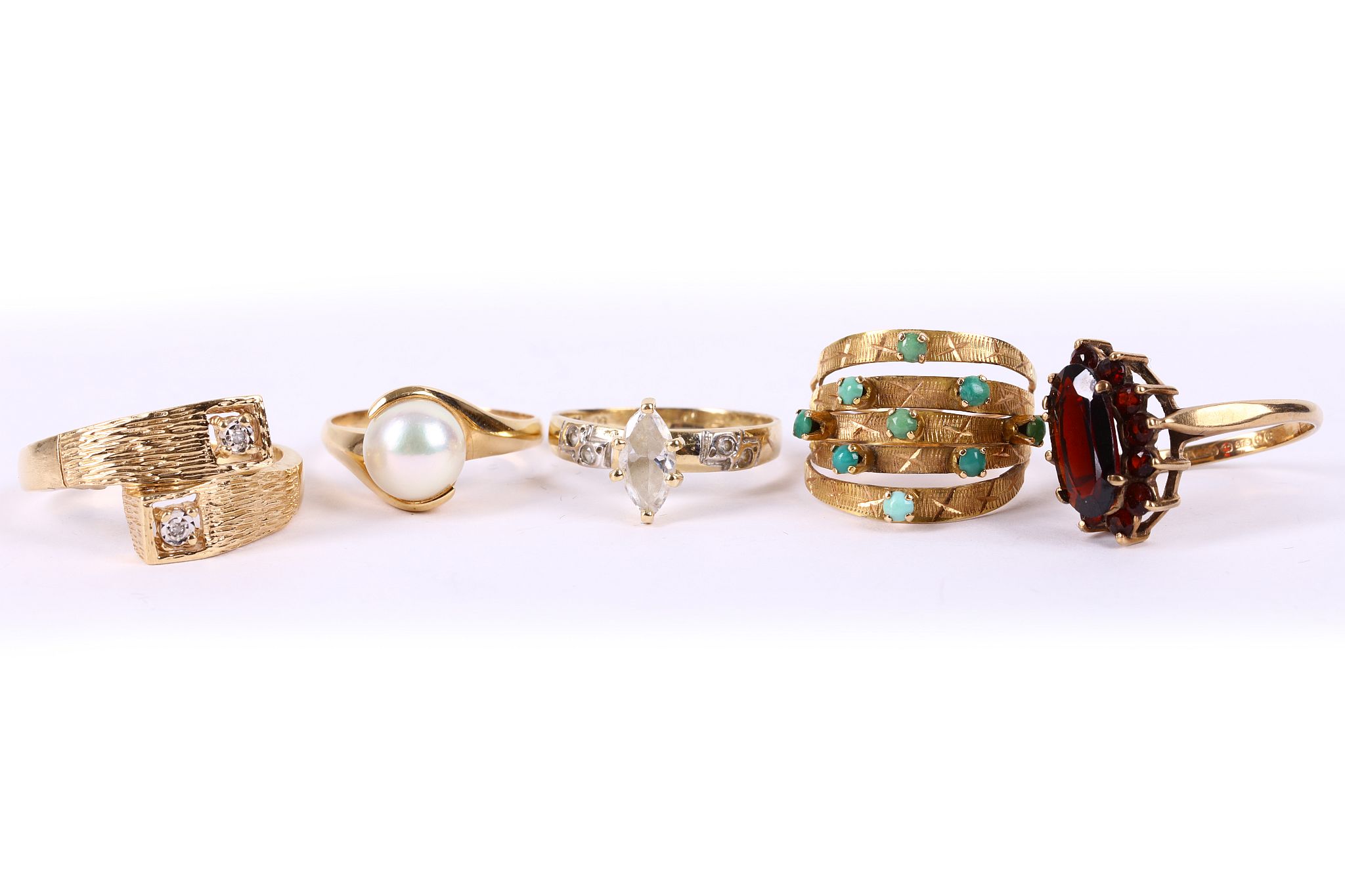 A small collection of five rings, Including a textured diamond crossover ring, stamped 14KP, a