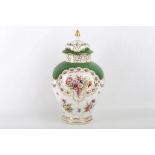 A very early Dresden lidded baluster vase, having green scale decoration and painted with floral