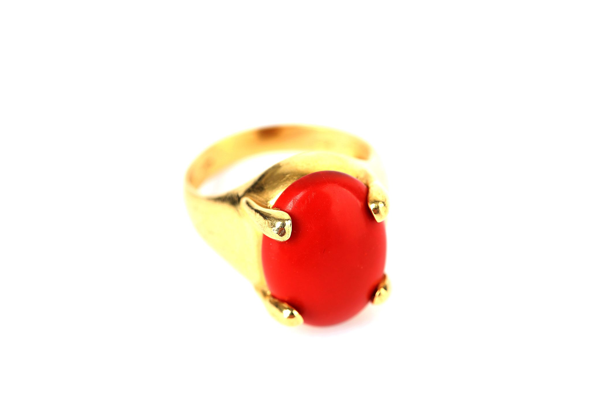 A coral ring, The oval coral corallium rubrum, in a four-claw setting, stamped 750, ring size M