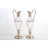 A pair of silver plated and cut glass ewers, 46cm.