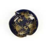 A Chinese gilt decorated monochrome blue leaf shaped dish, painted with bats and peaches, the base