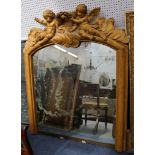 A large gilt overmantle mirror with an arched top surmounted with cherubs. 170 by 140 wide.