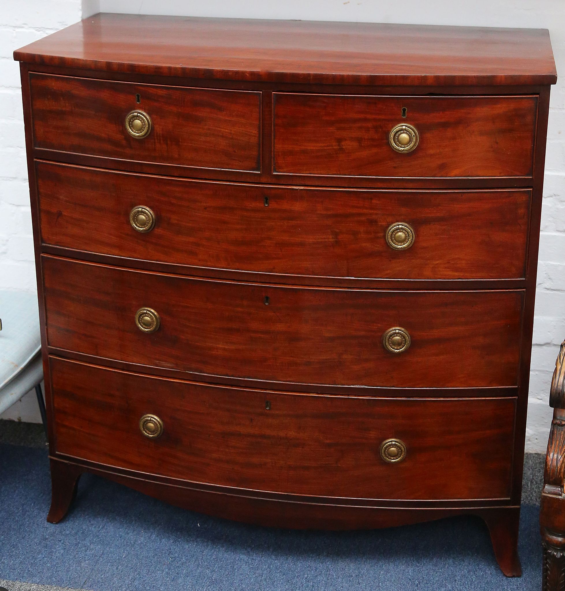 George IV mahogany bowfront chest fitted 2 short and 3 graduated long drawers on splay bracket feet,