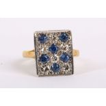 An 18K gold panel dress ring set with sapphires and diamonds. Size: N.