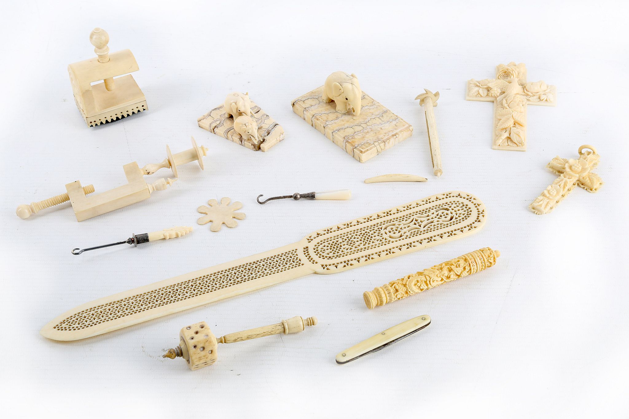 A collection of 19th century carved ivory items to include sewing related items such clamps bodkin