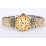 EBEL. A ladies stainless steel and 18K gold Ebel Wave bracelet watch, with champagne dial. Quartz.