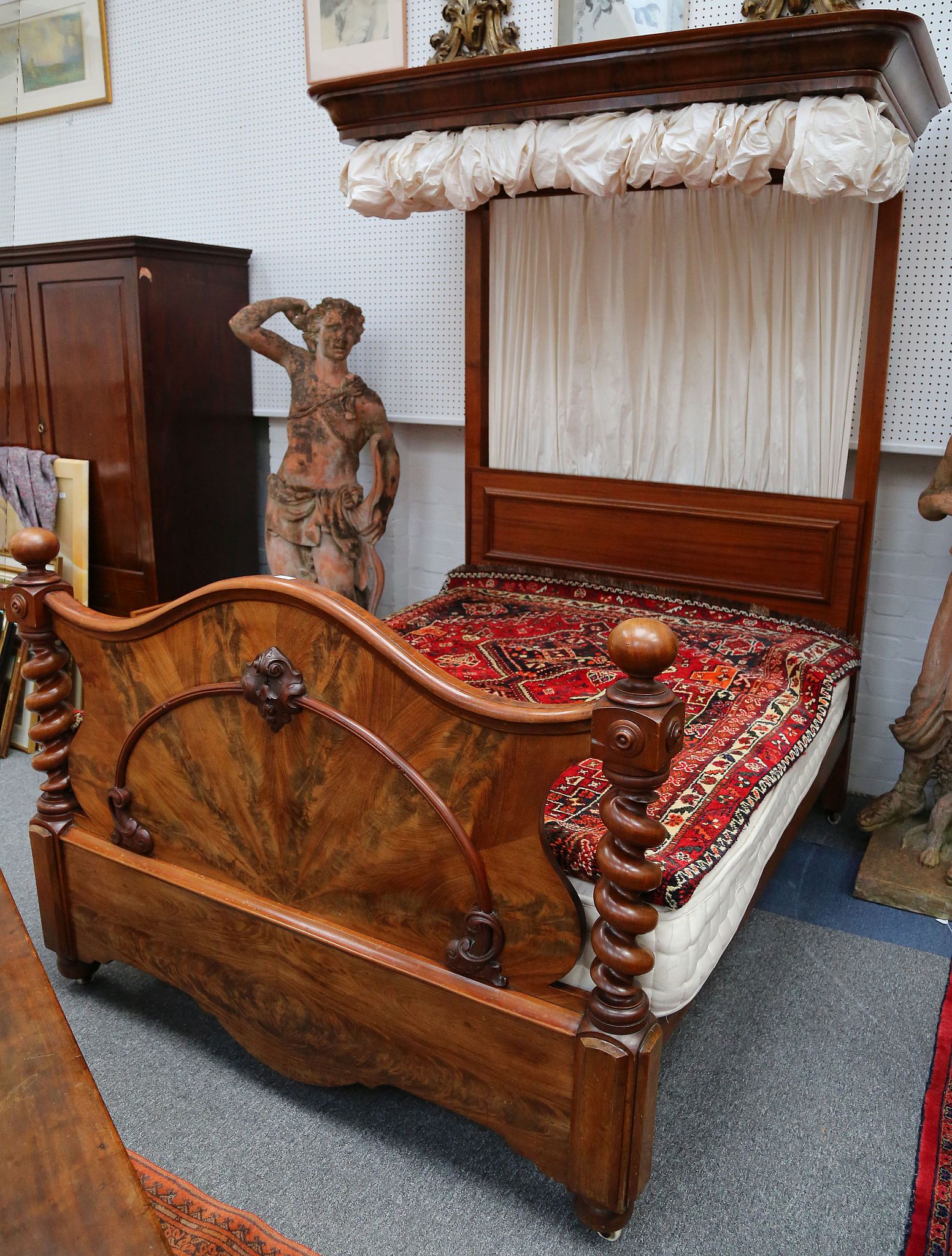 a Victorian half tester bed having a walnut veneered  cartouche form foot board between