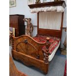 a Victorian half tester bed having a walnut veneered  cartouche form foot board between