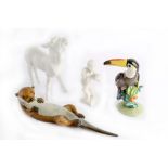 A 20th century Meissen Blanc de Chine model of a donkey, a Nymphenburg porcelain model of a parrot