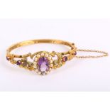 A Victorian style 9k yellow gold hinged bracelet, the central oval-faceted amethyst and pearl