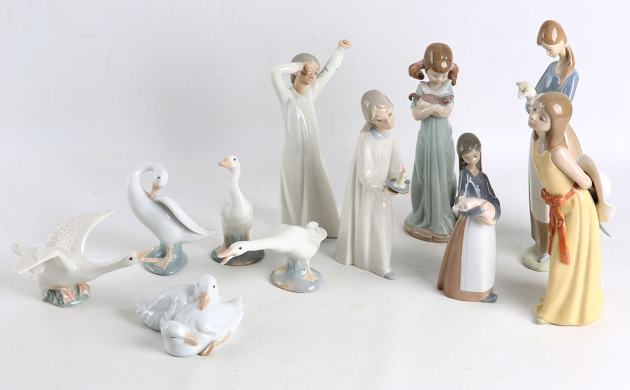 A collection of Lladro porcelain, to include four figures of ducks, and five figures of girls, one