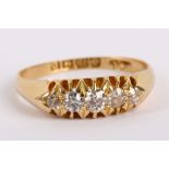 An 18K yellow gold and graduated diamond set five stone ring.