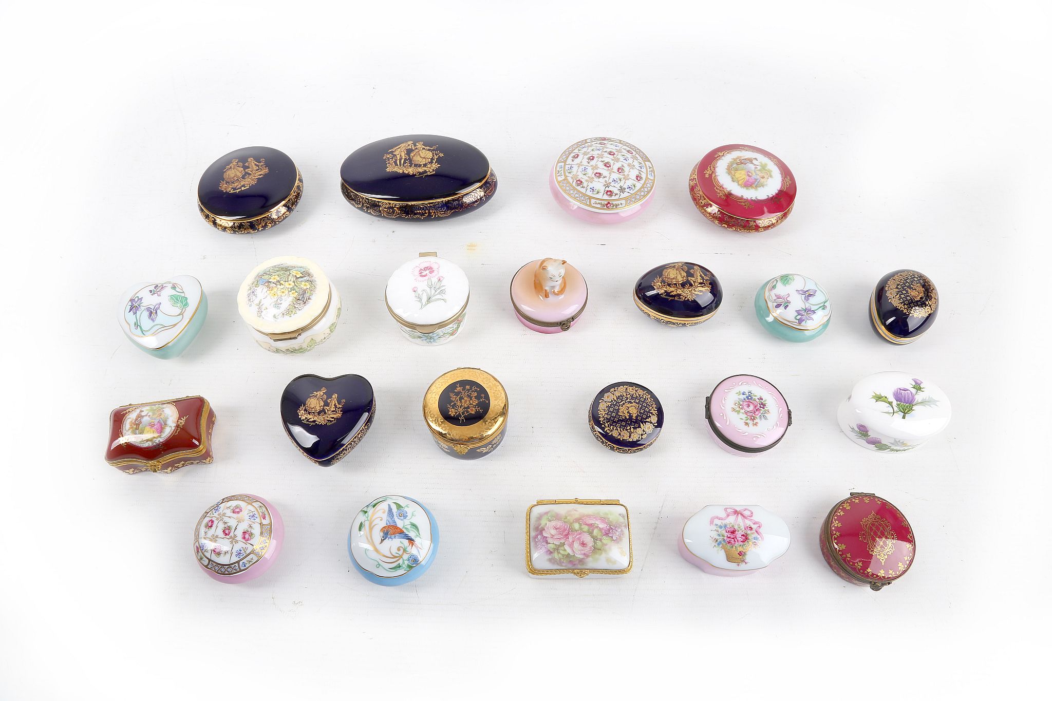 A collection of 20th century Limoges and other porcelain trinket boxes in various colours and