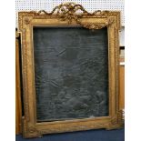 A large gilt mirror/picture frame with ribbon pediment, feature corners, egg and dart moulding