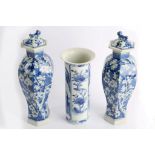 A pair of hexagonal section blue and white 'Prunus' decorated baluster form vases and covers,