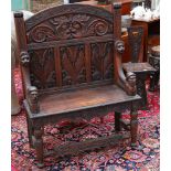 Late 19th / early 20th century Flemish panelled oak high back bench seat carved throughout with