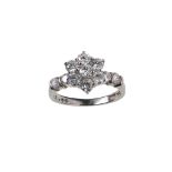 A platinum and diamond cluster ring Designed as a