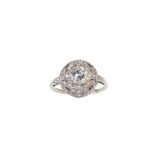 A diamond dress ring The brilliant-cut diamond, in a six-claw setting, to a pierced bombé surround
