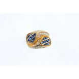 A sapphire and diamond crossover dress ring Each pear-shaped terminal channel-set with courses of