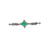 An emerald and diamond bar brooch, circa 1905 The millegrain collet-set oval cabochon emerald,