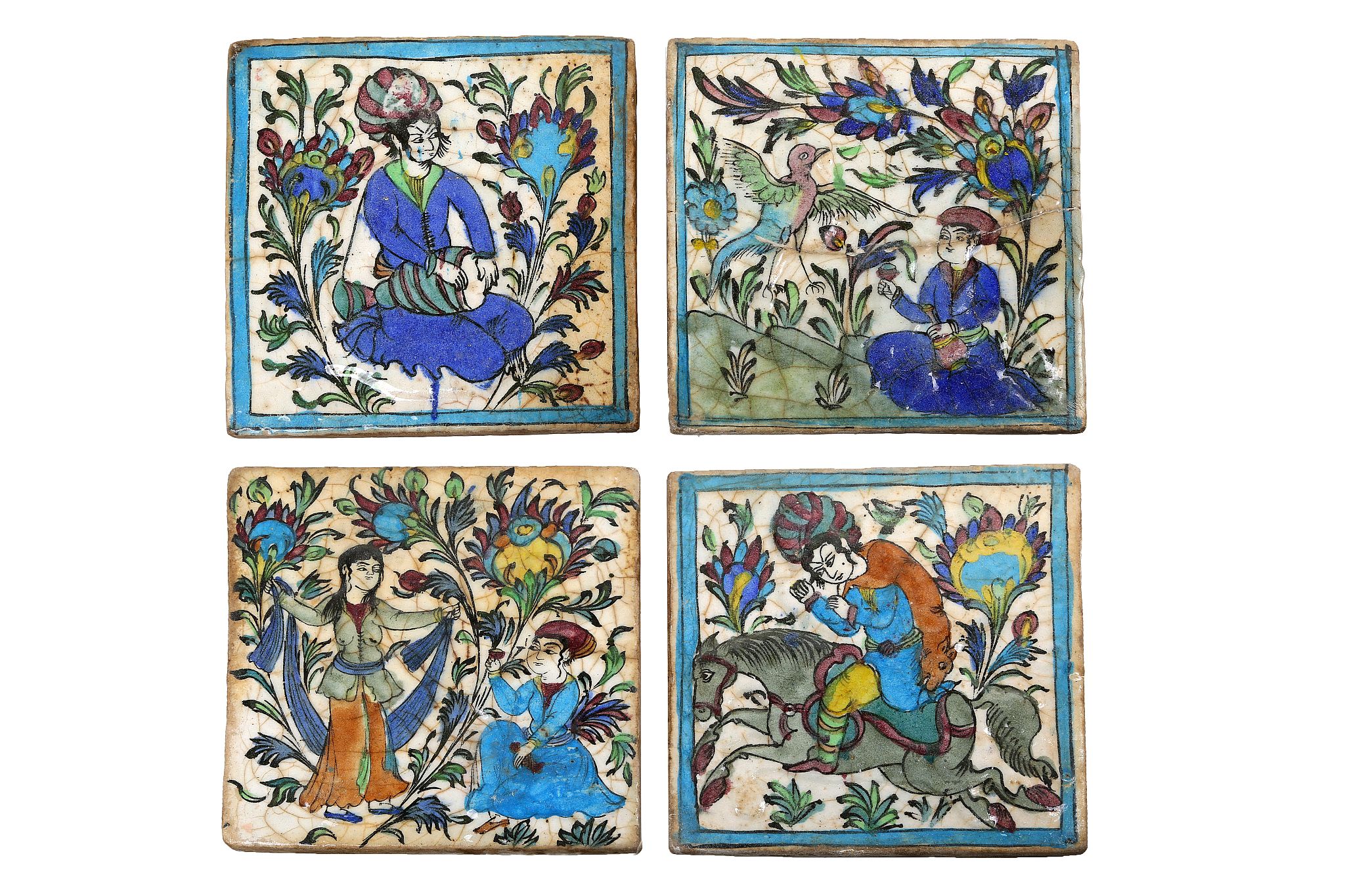 A set of four polychrome decorated Persian tiles, late 19th Century, each moulded in relief and