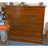 An Edwardian mahogany chest of drawers, with satinwood crossbanding to drawers, having two short