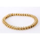 A 14k yellow gold and diamond set line bracelet. Diamond: 3.20ct total est.