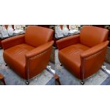 A pair of brown leather and chrome based armchairs, originally from the Bentley Car Showroom in