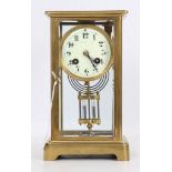 A Late 19th century French four glass brass mantle clock, with cream enamel dial with Arabic