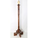 A Chinese carved wood lantern stand, supported on four scroll form feet with a cylindrical body with