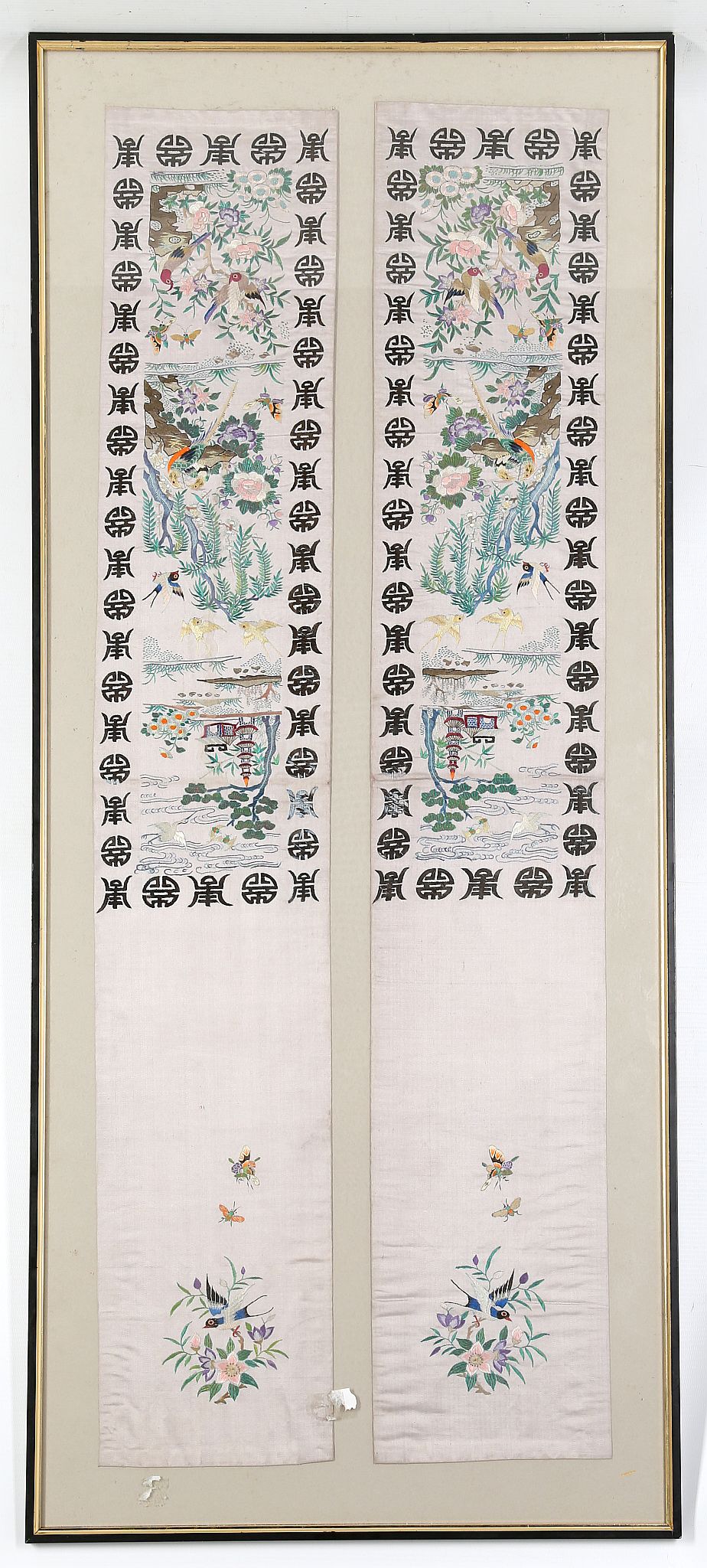 A pair of 20th Century Chinese embroidered panels of silk, depicting flora, fauna and script,