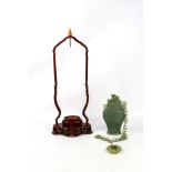 A Chinese jade hanging bottle with stand, together with a carved jade pendant, modeled as two