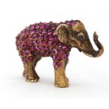 A Continental silver gilt elephant figure, decorated with cabouchon rubies and diamond set eyes.