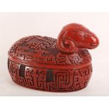 A 20th Century Chinese carved circular lacquer box and cover in the shape of seated sheep, carved in