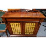 A Victorian mahogany chiffonier, enclosed by 2 brass grille doors on plinth foot, 107cm wide.