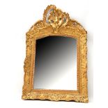 A ROCOCO STYLE GILTWOOD WALL MIRROR the frame decorated with trellis work, scrolls and flowers, with