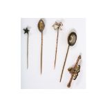 A collection of five pins, Including a paste and pearl spider stick pin, an enamel and diamond