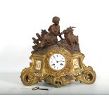 A LATE 19TH CENTURY FRENCH GILT AND PATINATED METAL FIGURAL CLOCK the case surmounted by a young
