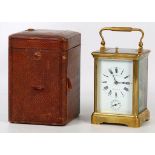 An Edwardian period brass and 5 glass carriage clock. The white enamelled face bearing the name Aug.