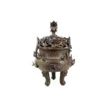 A 19th Century Chinese cast bronze incense burner, having pierced lid with dragon head finial, the