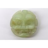 A Chinese or South East Asian, late 19th / very early 20th Century pale green jade belt buckle,
